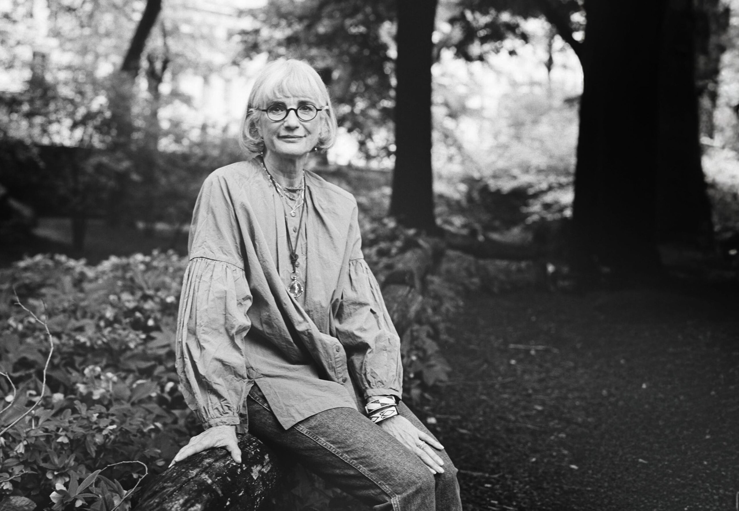Author Carol Davis seated outdoors in a garden